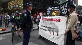 Protesters in Sydney, Australia block road for a minute’s silence for victims of climate change