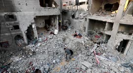 Palestinians gather at the rubble where senior Islamic Jihad commander Khaled Mansour was killed in Israeli strike