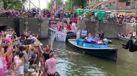 Colourful crowds enjoy Amsterdam's unique boat-borne Pride parade on the city's canals
