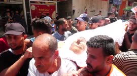 Relatives carry the body of Palestinian killed in an Israeli air strike, for his funeral