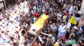Crowds of mourners attend the funeral of six Palestinians killed in Israeli air strikes in Gaza