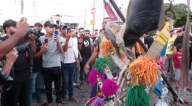 Palestinians gather at a scene after an Israeli air strike