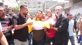 Palestinians carry body of child killed during Israeli air strike on Sunday
