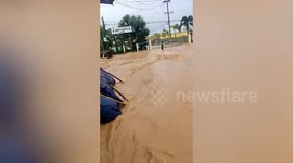 Summer thunderstorms turn town's roads into rivers in Myanmar