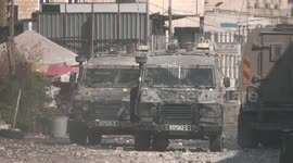 Palestinian protesters hurl rocks at Israeli security forces vehicles during raid