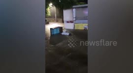 Locals wade through flooded road during deadly floods in Seoul, South Korea