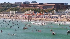 1_Packed Bournemouth beach full of sunbathers with the sea full of people enjoying the hot weather