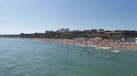 2_Packed Bournemouth beach full of sunbathers with the sea full of people enjoying the hot weather