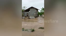 Family's home collapses while being battered by flash floods in the Philippines