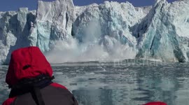 Stunning close glacier calving filmed from a boat in Svalbard, Norway