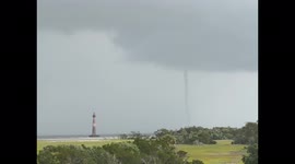 Impressive waterspout caught on camera by Morris Island Lighthouse at Folly Beach, South Carolina
