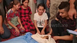 Palestinian children cry around 10-year-old girl killed by Israeli airstrike