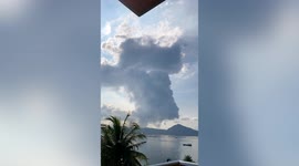 Plumes of gas expelled from Taal Volcano blanketing homes in smog in the Philippines