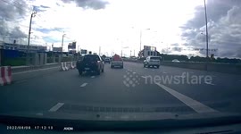 Plastic boat flies off pickup truck's cargo bed onto motorway in Thailand