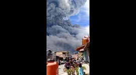 Mount sinabung erupting - clouds fill with black smoke in Indonesia