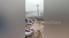 Flash floods sweep vehicles down roads as rainstorm hits northern China