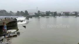 Bridge collapses into flooded river due to rainstorm in eastern China