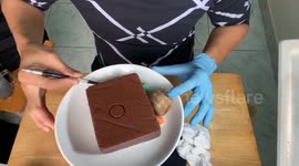 Man sculpts beautiful 3D flower on top of a chocolate jelly cake