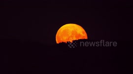 Fiery full Sturgeon supermoon rises over 'Stonehenge of the north'
