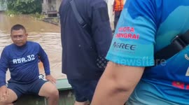 Storm Mulan relief workers wade through NECK DEEP floods to reach stranded locals in Thailand