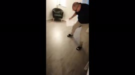 Chasing and catching a spider running across the floor