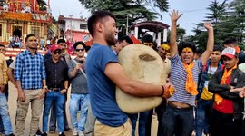 Men spanning all ages compete in ritual to lift a heavy stone