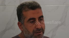 Palestinian parents of Khalil Abu Hamada who was killed in an Israeli airstrike, sit at their home