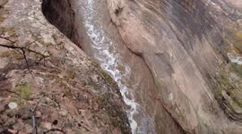 Man overlooks flash floods in slot canyon within Zion National Park, US
