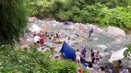 Locals evacuate ditch to escape fast-flowing floodwater in southern China