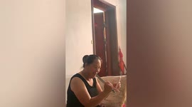 Chinese woman uses large knife to pick food out of her teeth