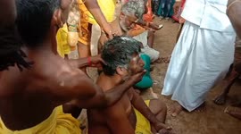 Coconuts broken on devotees' heads during festival in India