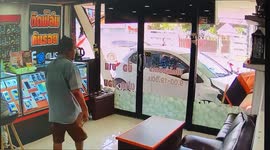 Quick-thinking pedestrian dodges out-of-control car as it crashes into shop