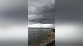 Long waterspout sparks panic among villagers after forming off the coast in the Philippines