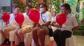 Wedding guests play hilarious balloon blowing up game at reception
