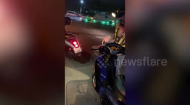 Baby python slithers on handlebars of moving motorbike in Thailand