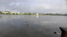 Yoga guru floats on lake with national flag to promote awareness in eastern India