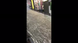 Floodwater gushes down street as thunderstorm hits Istanbul