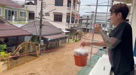 Resourceful neighbours use pulley to deliver meals across flooded street