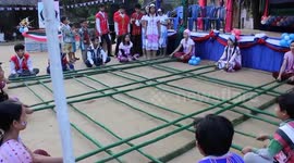 Burmese dancers gracefully hop between wooden poles in traditional Kayin bamboo dance