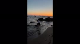 EPIC FAIL Man falls into sea in front of beautiful Greek sunset