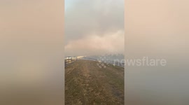 Grasslands burn next to Rosario-Victoria link road in Argentina