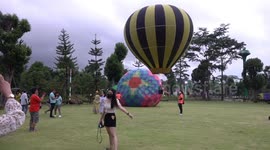 Colourful hot air balloons fill the sky during balloon festival in Thailand