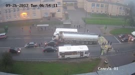 Car crash - driver not paying attention while passing at bus stop crashes into back of braking car (CCTV Video)