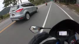 Close call: car tries to overtake in oncoming lane, but motorbike sped up