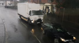 On the approach to Romford Town center a heavy downpour of rain falls down.