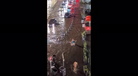 People trudge through water as thunderstorm hits France