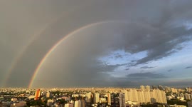 Breathtaking double rainbow forms after rain over Bangkok, Thailand