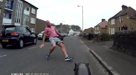 Angry man attempts to kick and injure cyclist. Cyclist get last laugh as angry man falls over.