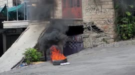 Palestinian protesters hurl stones and burn tires during clashes with Israeli forces