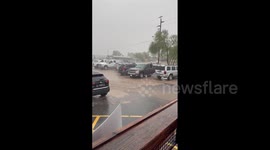 Parking lot becomes muddy torrent as monsoon storms bring heavy rain and flooding to Arizona